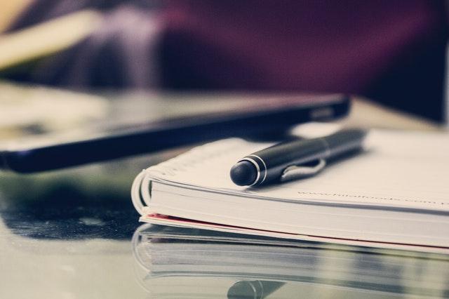 Notebook with a pen on a table