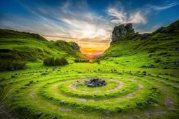 Thumbnail sized: A meadow with a stone pile in center and concentric circles around it
