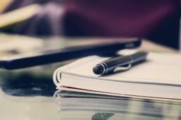 Thumbnail sized: Notebook with a pen on a table